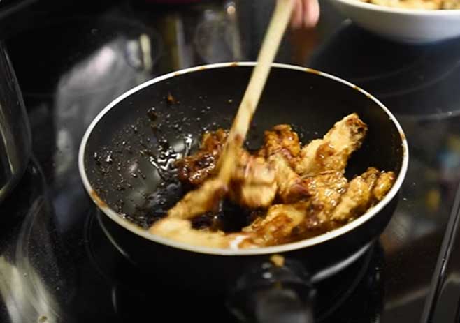 Mixing Wings With Sauce: