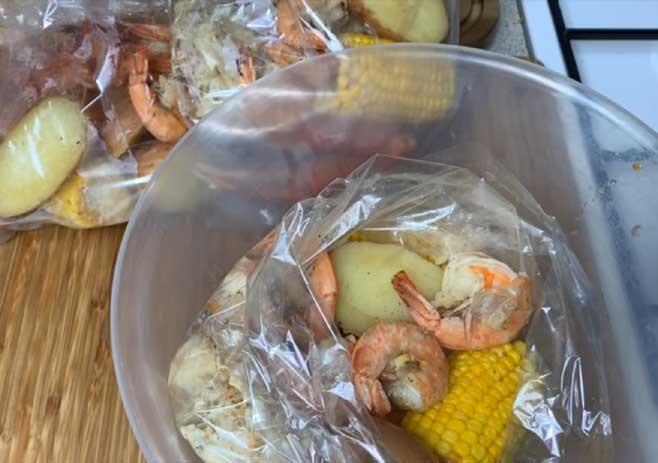 Layer the seafood and vegetable inside a bag