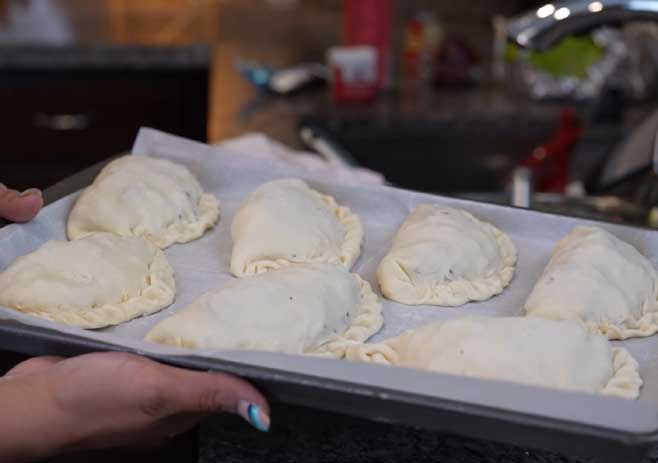set the empanada on the baking sheet