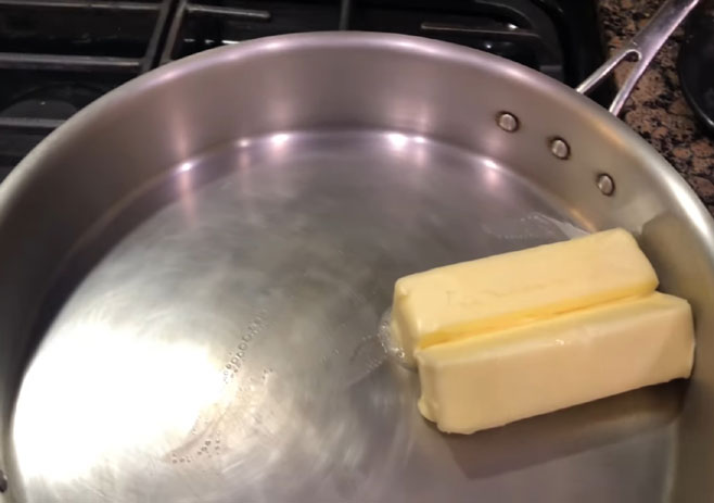 Place the cooking pan on the stove and add butter
