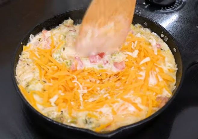 Pour in evaporated milk and grated cheese