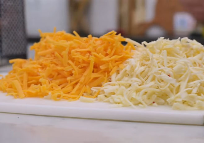 Shred the cheeses with a grater