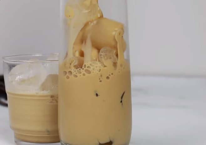 Pour caramel coffee over ice