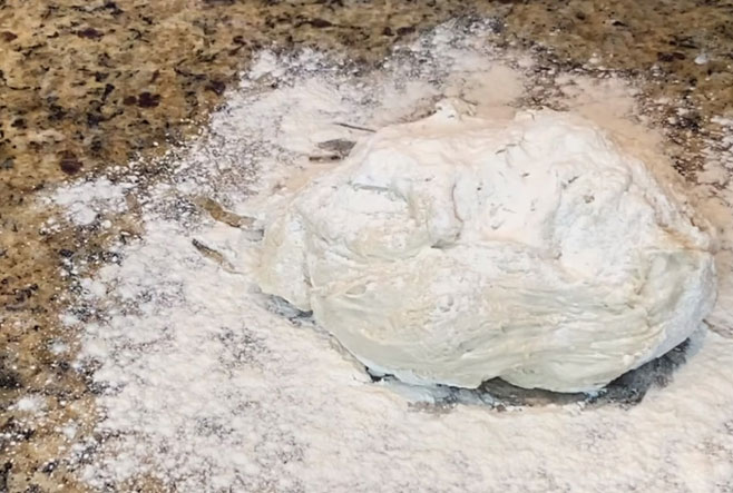 Spread flour over the dough