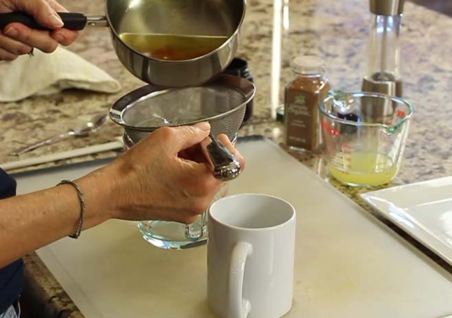 Strain ginger and turmeric from water