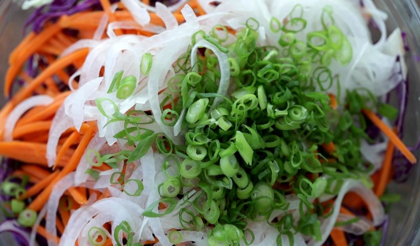 Add all the sliced vegetables to a bowl and mix