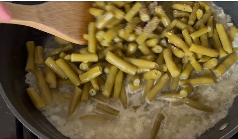 Pouring the chicken broth and add the green beans