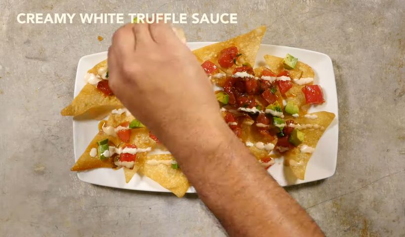 Pouring the creamy white truffle sauce