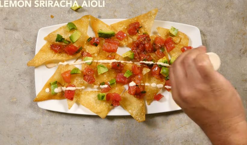 Pouring the sriracha aioli and sweet soy: