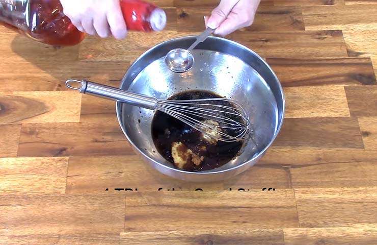 Adding-bourbon-and-whisk-the-mix