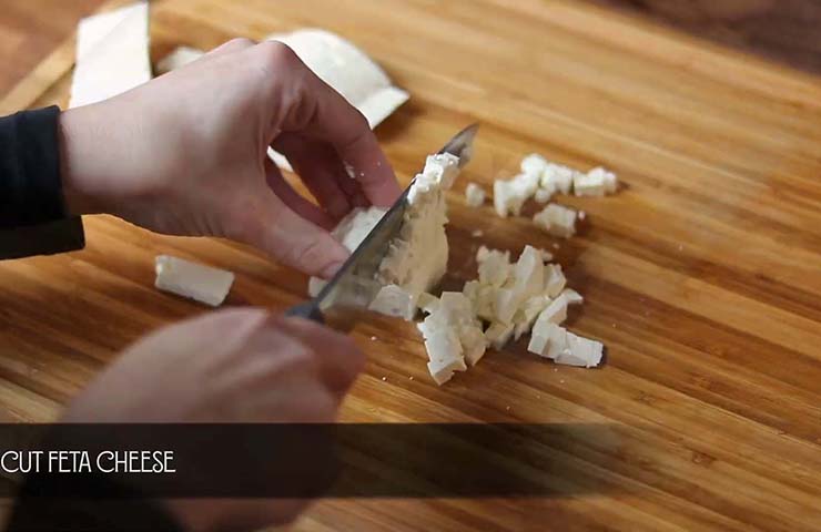 Slice the strawberries, red onions, and feta cheese